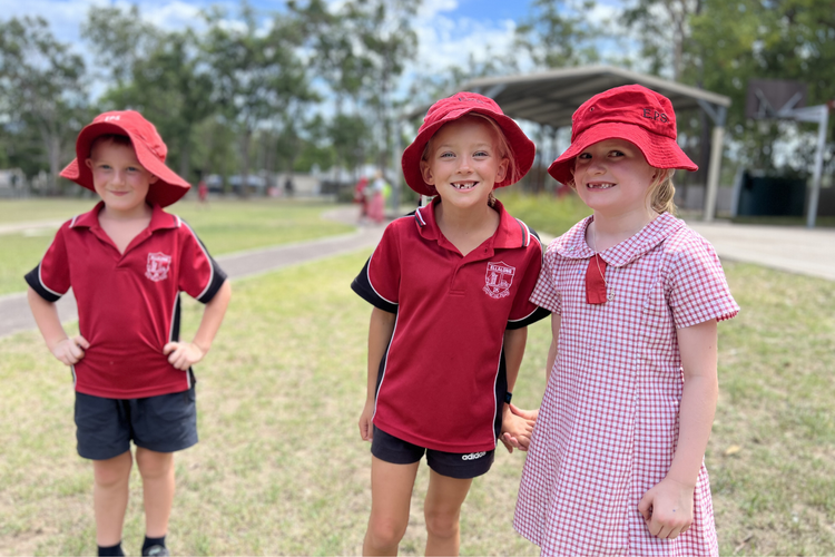 An image of three happy students smiling on the school val.